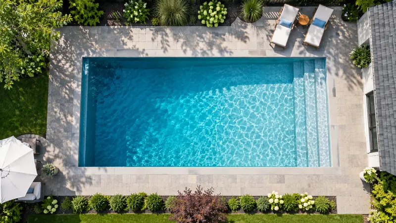 Aerial view of a rectangular backyard pool showing the shallow end to deep end gradient